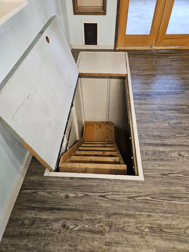 stairs featuring hardwood / wood-style floors