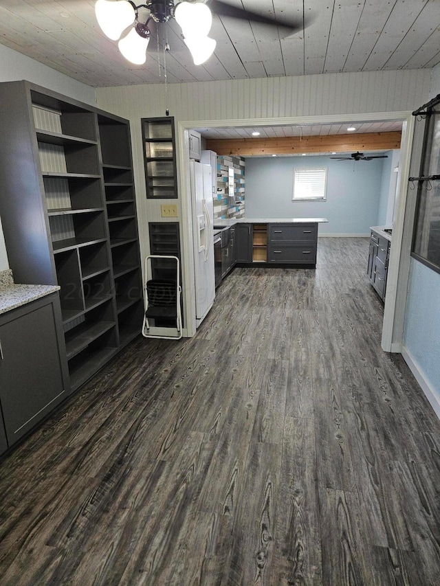 kitchen featuring wood walls, dark hardwood / wood-style floors, ceiling fan, white refrigerator with ice dispenser, and gray cabinets