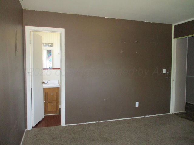 1502 Lancelot St, Borger, TX 79007 - unfurnished bedroom with carpet, a sink, a closet, and ensuite bath
