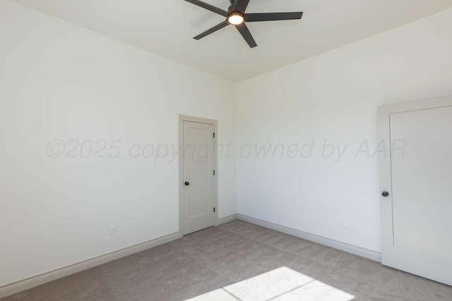 unfurnished room featuring light carpet, a ceiling fan, and baseboards