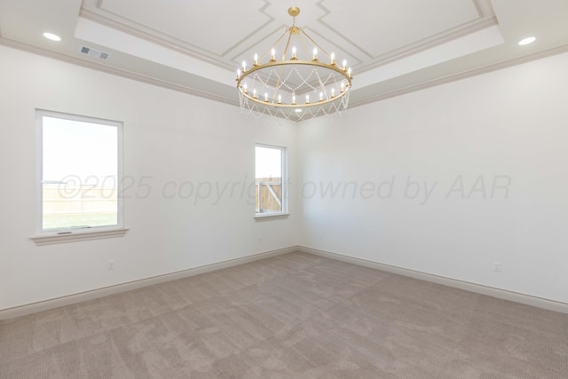 carpeted empty room featuring recessed lighting, a raised ceiling, visible vents, ornamental molding, and a notable chandelier
