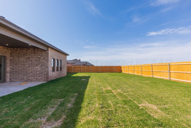 view of yard featuring a patio area and a fenced backyard
