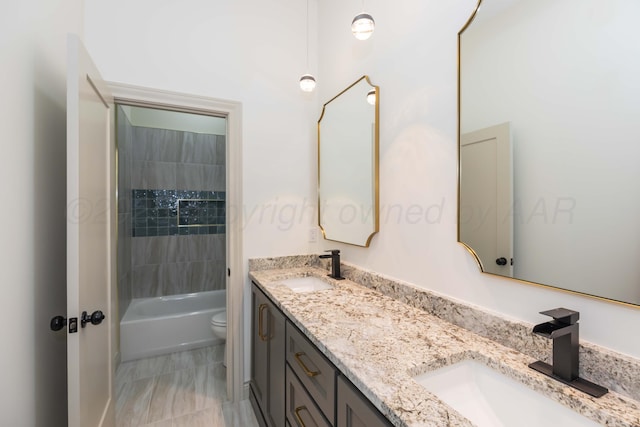 bathroom featuring  shower combination, a sink, double vanity, and toilet
