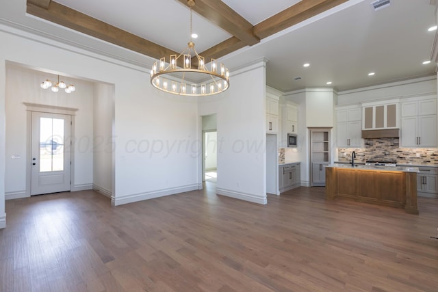 kitchen featuring backsplash, a chandelier, and light countertops
