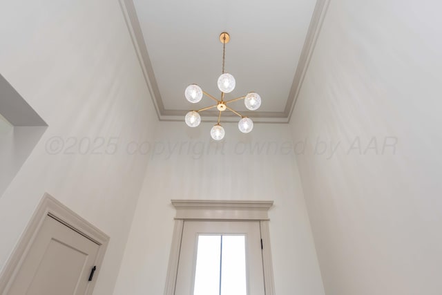 details with a notable chandelier and crown molding