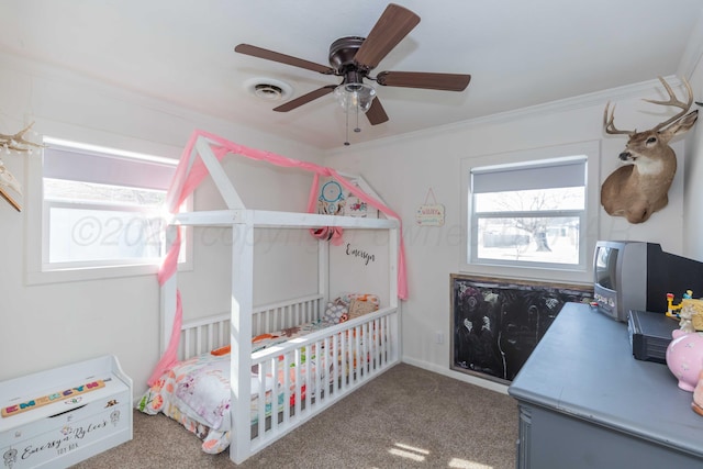 bedroom with visible vents, crown molding, carpet flooring, and ceiling fan