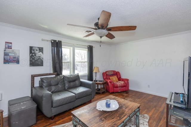 living area with dark wood-style floors, crown molding, ceiling fan, a textured ceiling, and baseboards