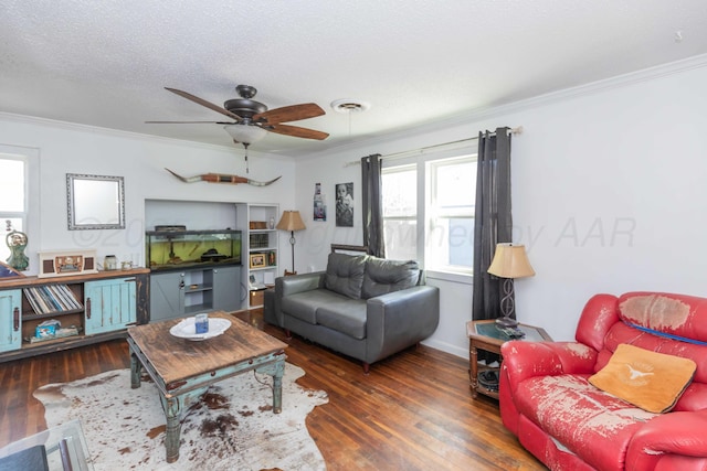 living room featuring visible vents, dark wood-style floors, ceiling fan, a textured ceiling, and crown molding