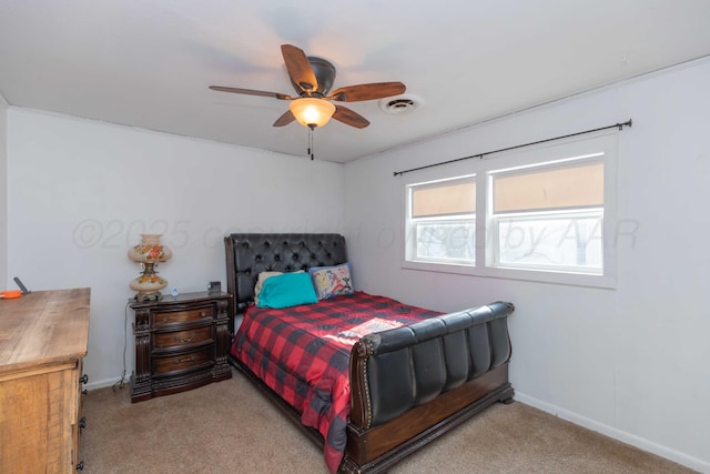 bedroom with light carpet, a ceiling fan, visible vents, and baseboards