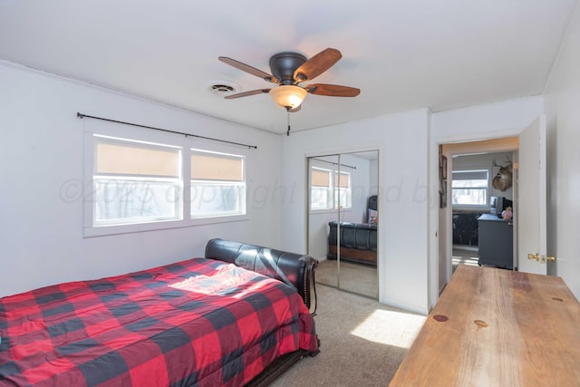 bedroom with ceiling fan, a closet, carpet flooring, and visible vents