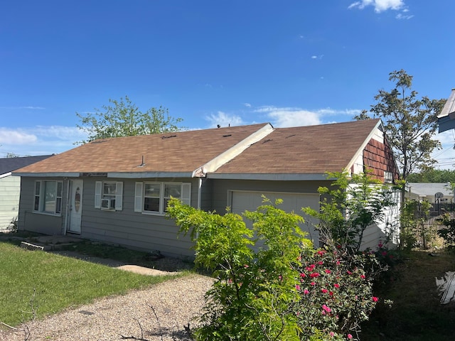 106 Peiffer St, Borger, TX 79007 - view of side of property with roof with shingles, an attached garage, and cooling unit