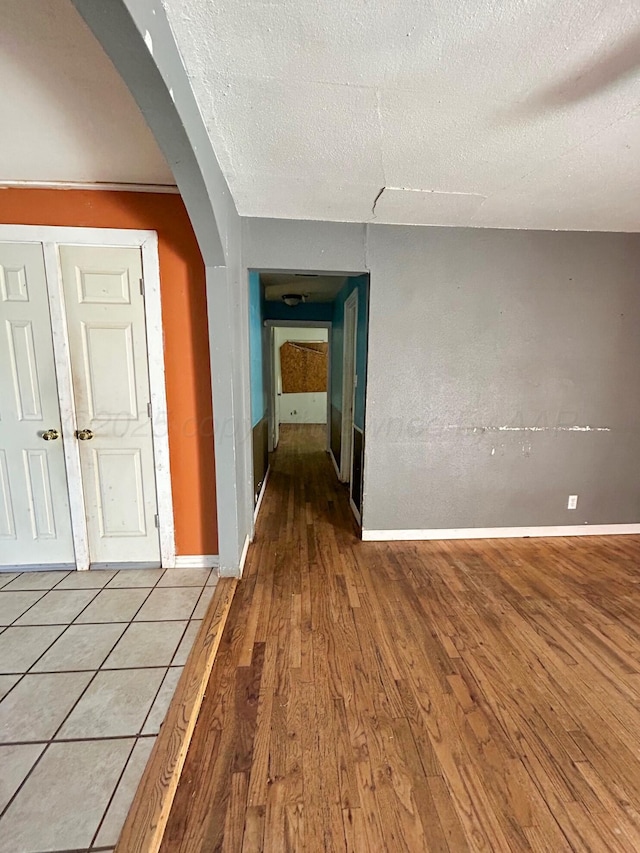 corridor featuring hardwood / wood-style floors and a textured ceiling