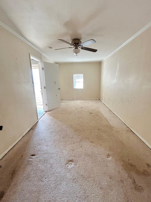 empty room featuring light carpet, ornamental molding, and ceiling fan