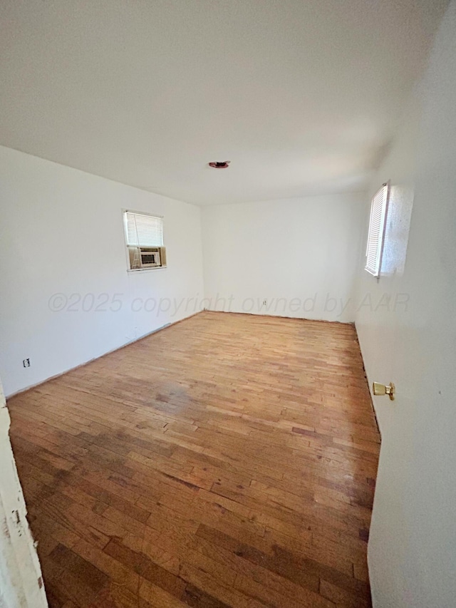 unfurnished room featuring hardwood / wood-style flooring and cooling unit