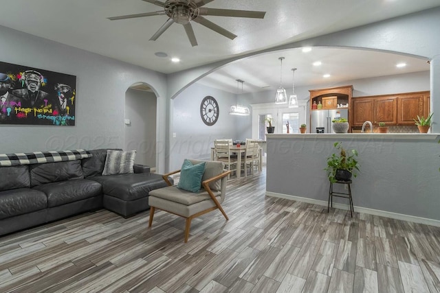 living room featuring light hardwood / wood-style flooring and ceiling fan