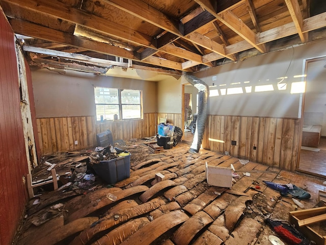 interior space with a wainscoted wall and wood walls