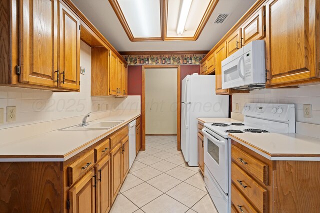 6701 Admiral Ct, Amarillo, TX 79124 - kitchen featuring white appliances, brown cabinetry, decorative backsplash, light countertops, and light tile patterned flooring