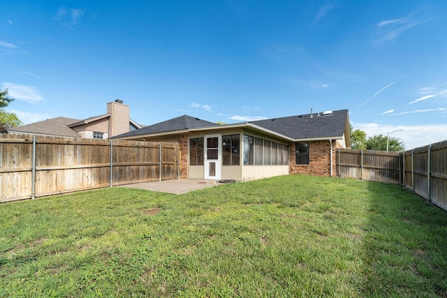6701 Admiral Ct, Amarillo, TX 79124 - back of house featuring brick siding, a sunroom, a fenced backyard, a patio, and a shingled roof