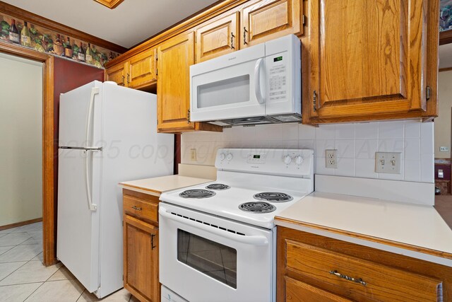 6701 Admiral Ct, Amarillo, TX 79124 - kitchen featuring white appliances, backsplash, light countertops, brown cabinetry, and light tile patterned floors