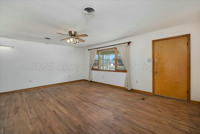 empty room with hardwood / wood-style floors and ceiling fan