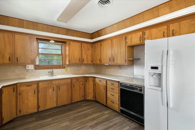 kitchen with dark hardwood / wood-style flooring, tasteful backsplash, sink, white refrigerator with ice dispenser, and dishwasher