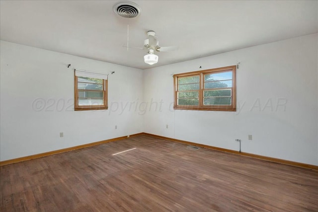 spare room featuring ceiling fan, plenty of natural light, and hardwood / wood-style floors