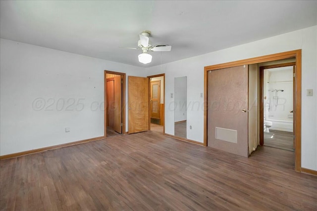 unfurnished bedroom featuring ensuite bath, ceiling fan, and wood-type flooring