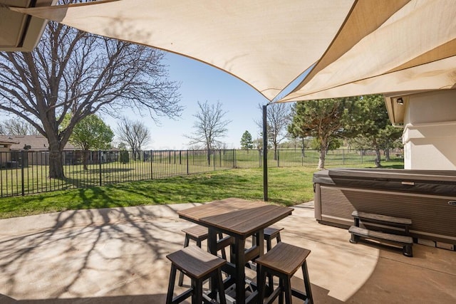 view of patio with outdoor dining space, a fenced backyard, and a hot tub