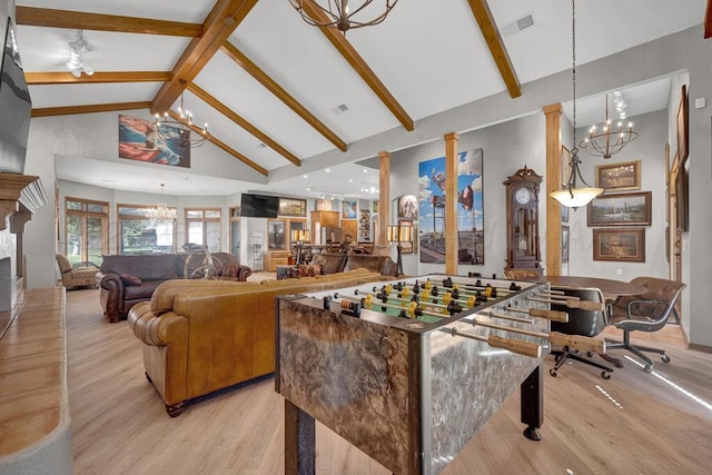 recreation room featuring beamed ceiling, a notable chandelier, high vaulted ceiling, and light wood-type flooring