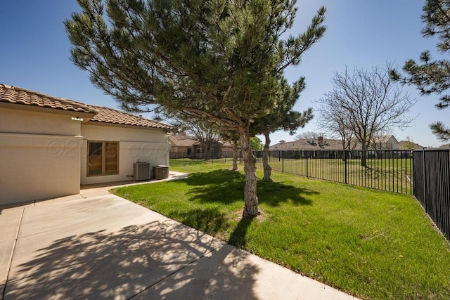 view of yard with a patio, central AC, and fence private yard