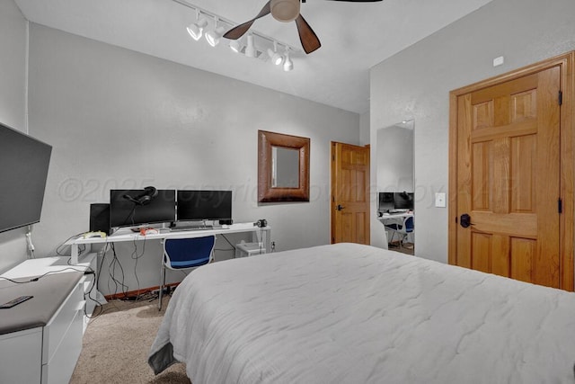 bedroom with track lighting, ceiling fan, and carpet flooring