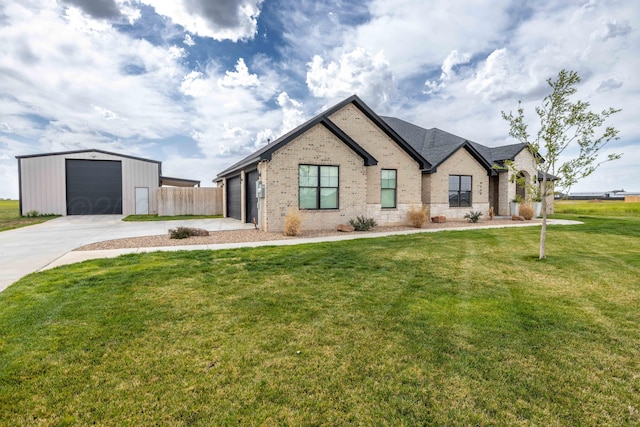 view of front of house featuring fence, a front lawn, driveway, an outbuilding, and brick siding