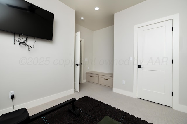 workout room with baseboards, light carpet, and recessed lighting