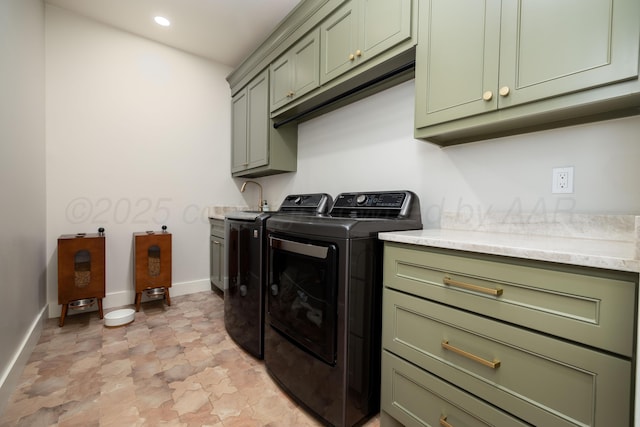 washroom with cabinet space, baseboards, washer and dryer, and recessed lighting