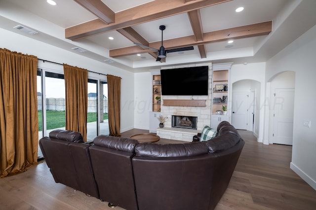 living area featuring baseboards, a ceiling fan, visible vents, and coffered ceiling