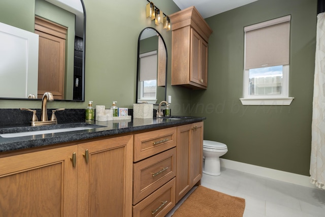 bathroom with double vanity, a wealth of natural light, and a sink