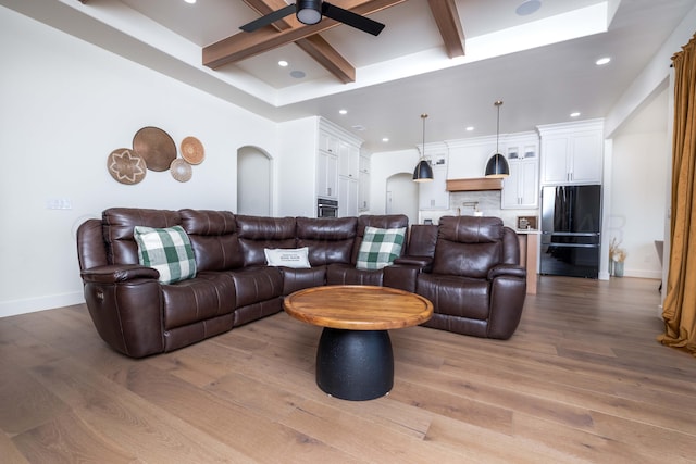 living room with recessed lighting, coffered ceiling, wood finished floors, a ceiling fan, and beamed ceiling