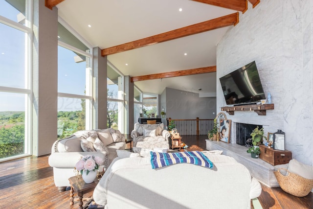 2 Altamira St, Borger, TX 79007 - living area with beamed ceiling, hardwood / wood-style floors, healthy amount of natural light, a stone fireplace, and high vaulted ceiling