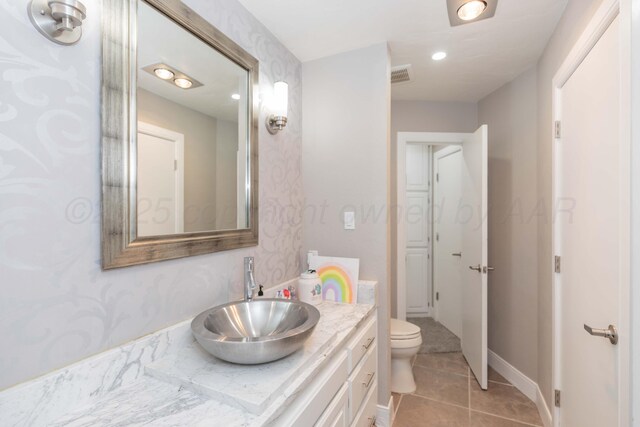 2 Altamira St, Borger, TX 79007 - bathroom with vanity, tile patterned flooring, toilet, and recessed lighting