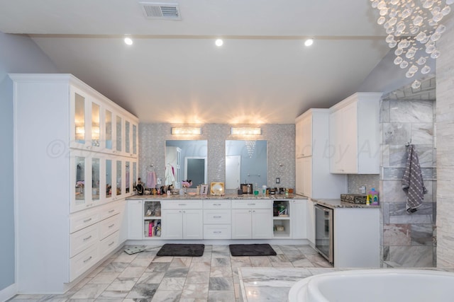 2 Altamira St, Borger, TX 79007 - full bath featuring vanity, a bathtub, tasteful backsplash, and beverage cooler