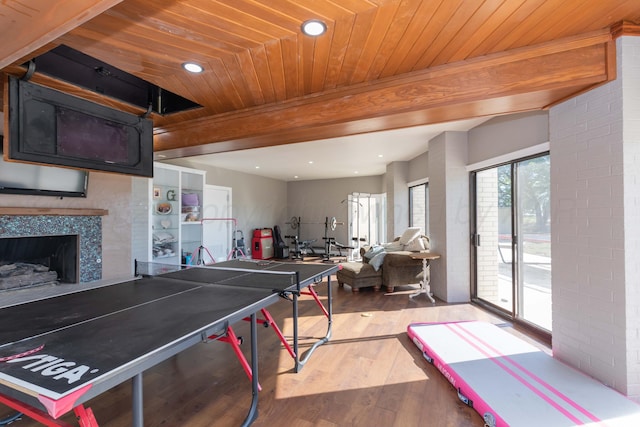2 Altamira St, Borger, TX 79007 - recreation room featuring wood finished floors, beamed ceiling, wooden ceiling, recessed lighting, and a tile fireplace