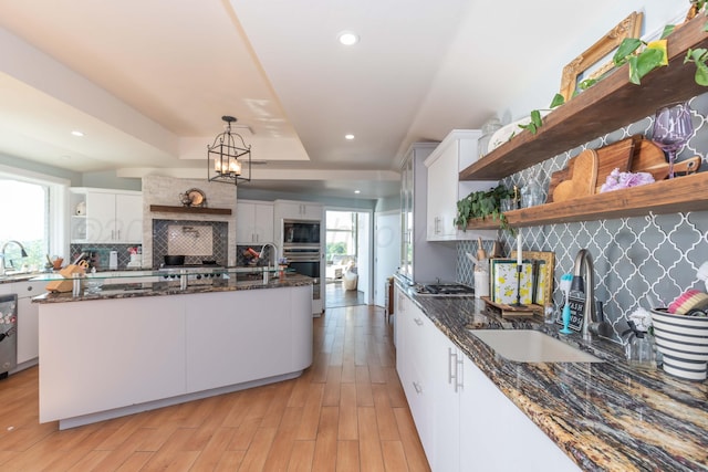 2 Altamira St, Borger, TX 79007 - kitchen featuring open shelves, a sink, appliances with stainless steel finishes, white cabinets, and recessed lighting