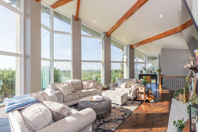 2 Altamira St, Borger, TX 79007 - living room with high vaulted ceiling, wood finished floors, beamed ceiling, plenty of natural light, and a wall of windows