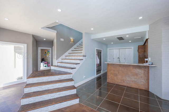 2 Altamira St, Borger, TX 79007 - staircase featuring tile patterned flooring, baseboards, and recessed lighting