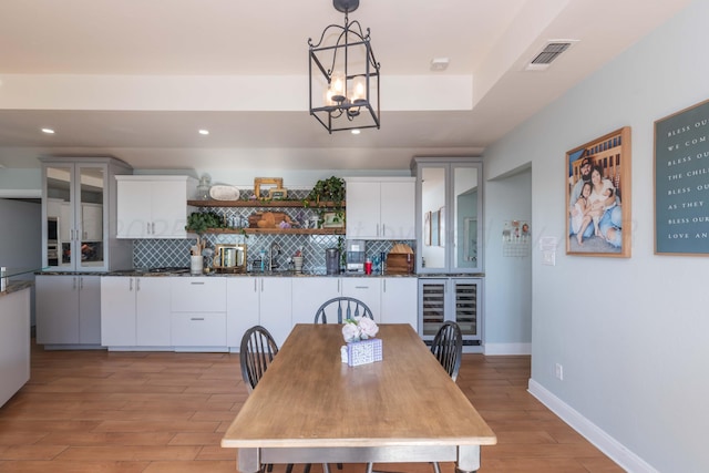 2 Altamira St, Borger, TX 79007 - dining space with beverage cooler, a chandelier, light wood-type flooring, recessed lighting, and baseboards
