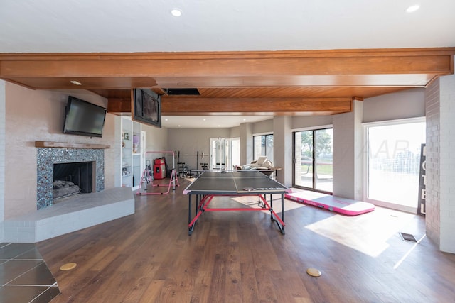 2 Altamira St, Borger, TX 79007 - playroom with beam ceiling, dark wood-style floors, a fireplace with raised hearth, and recessed lighting