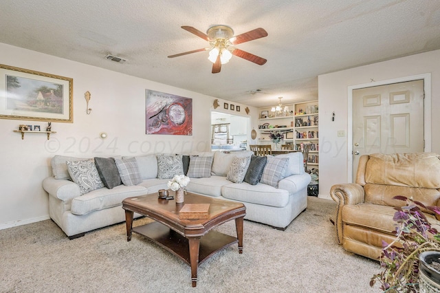 carpeted living room with ceiling fan and a textured ceiling