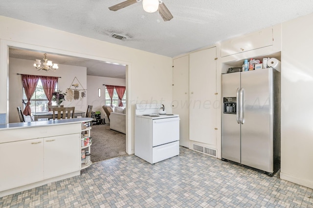 kitchen with white electric range oven, white cabinetry, stainless steel fridge with ice dispenser, hanging light fixtures, and a textured ceiling