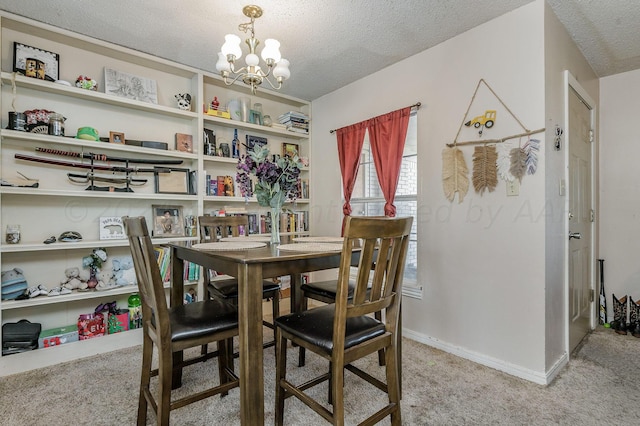 carpeted dining room with a textured ceiling and a chandelier