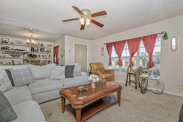 carpeted living room featuring ceiling fan with notable chandelier and a textured ceiling